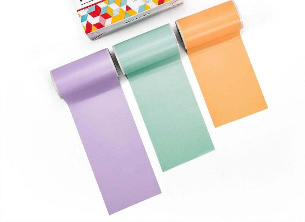 Three rolls of printer paper in purple, green, and orange with a box labeled 'Printer Paper' on a white background.